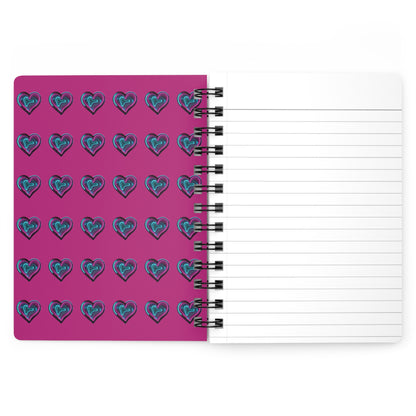 A spiral notebook with interior view. The inside of the cover has a Fuchsia background and the same neon hearts as the front cover, However the hearts are small and aligned in column and row.